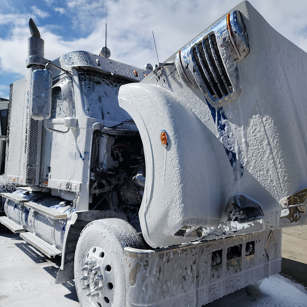 Clean truck covered in white foam during wash
