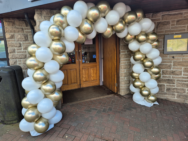 Large gold and white balloon arch