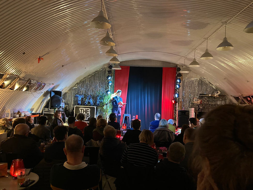 Nick Wallis on stage reading from The Great Post Office Scandal at the Wanstead tap