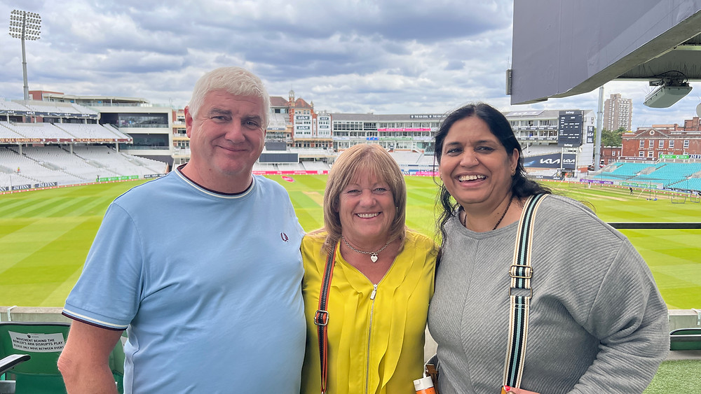 Kevin and Sharon Brown and Seema Misra with The Oval Cricket Ground behind them
