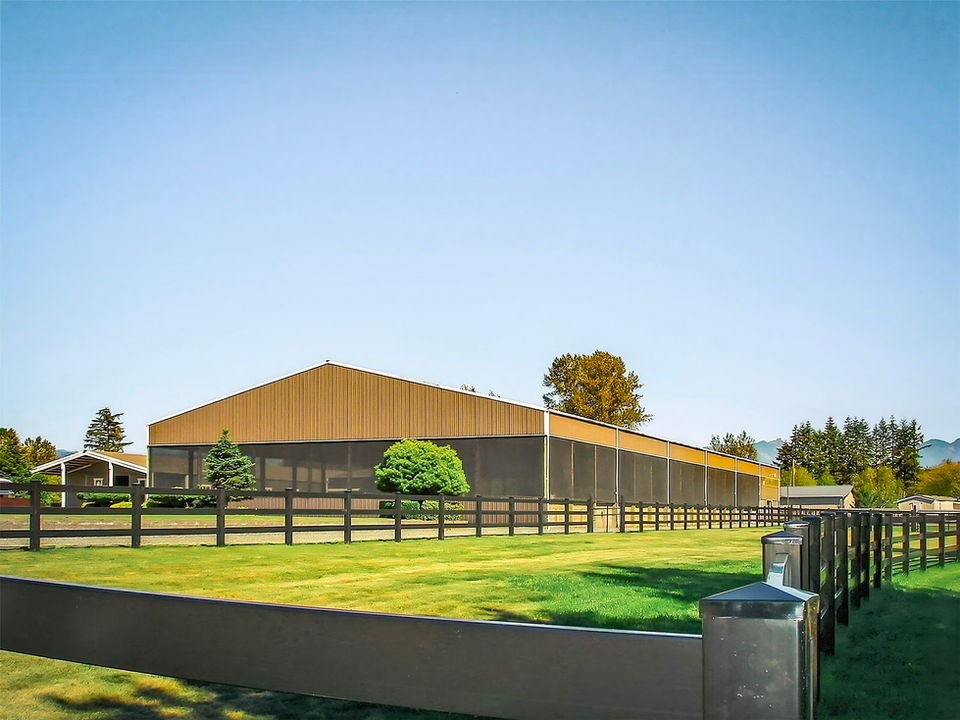 Exterior view of the indoor dressage arena at Seven Hills Training Monroe WA
