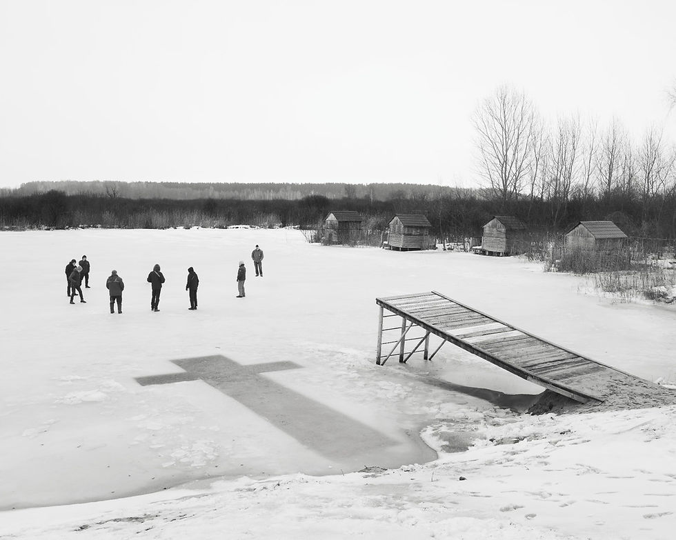 People stand on a frozen lake near a cross-shaped cutout. "Wet ground" by Aria Shahrokhshahi