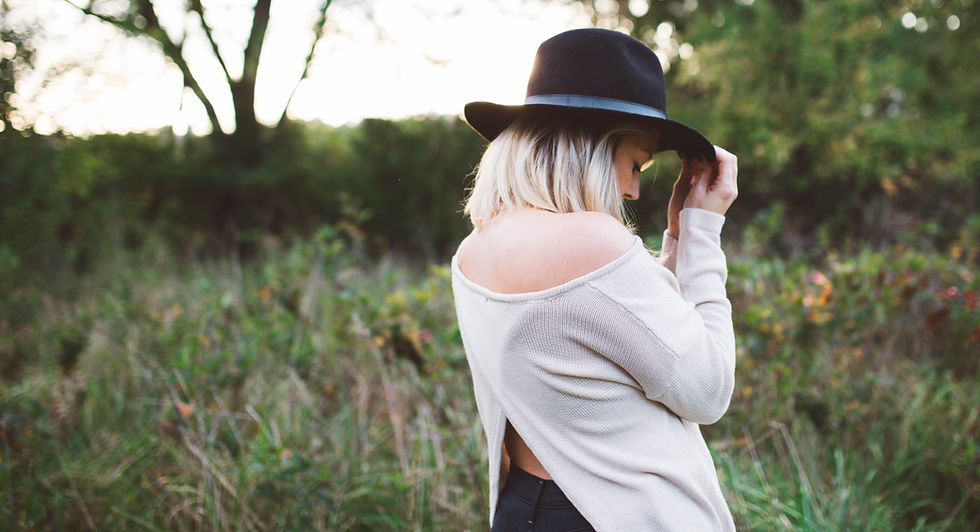woman with blonde hair wearing a black hat
