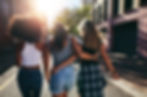 Three women of different ethnicities walking together