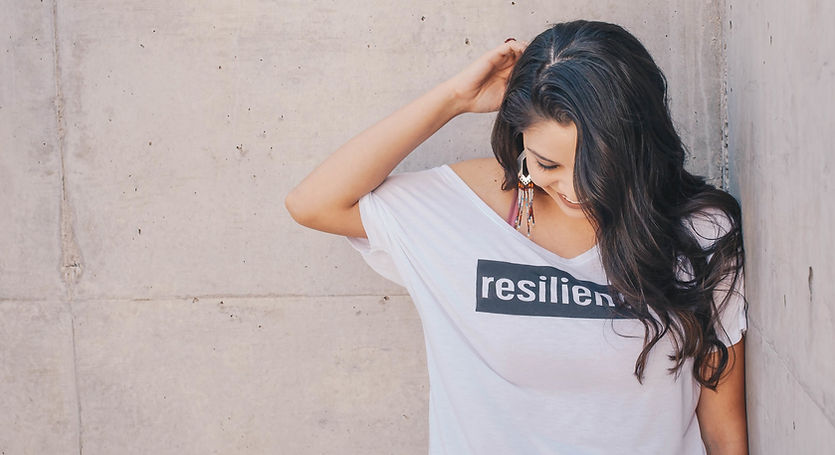 Woman wearing shirt that says Resilient