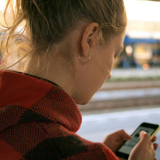 woman walking while searching on her phone