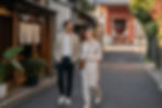 AI-generated concept: a couple walking together along a traditional Japanese neighborhood street in daylight.