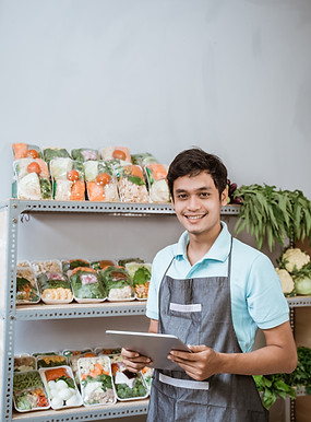 portrait-smiling-young-man-standing-against-wall.jpg