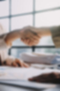 businesswoman-shaking-hands-with-businessman-desk-office.jpg