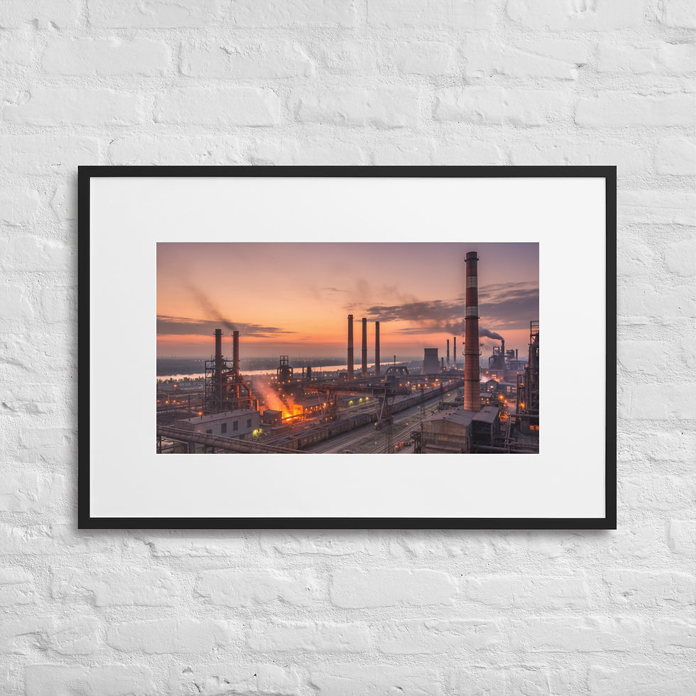 Wide-angle view of a large refinery or industrial plant at sunset, with tall smokestacks and glowing lights.