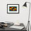 Thumbnail: Modern graphic wall art featuring a pattern of primary-colored semicircles in a black frame above a desk.