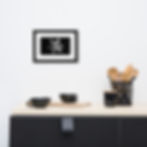 Abstract black and white print featuring a stylized flower made of thick white brushstrokes on a black background.