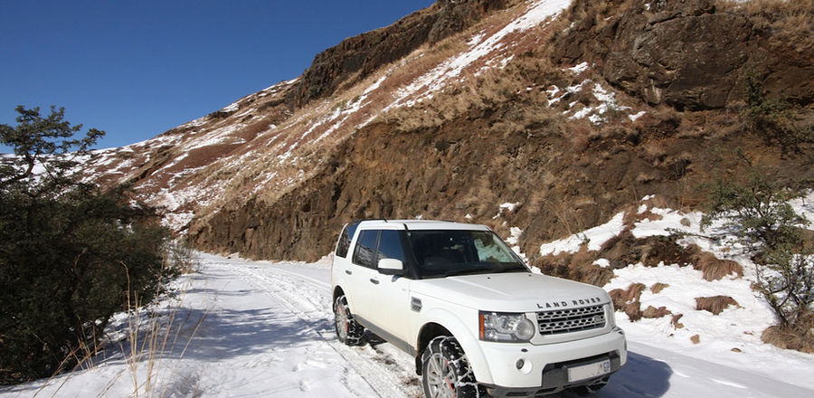 4x4 fitted with snow chains on a mountain pass