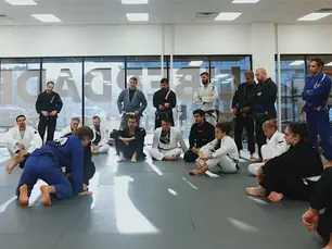 Adult and youth students at Liberdade BJJ in Nashville practicing Brazilian Jiu Jitsu with instructor coaching problem-solving techniques.