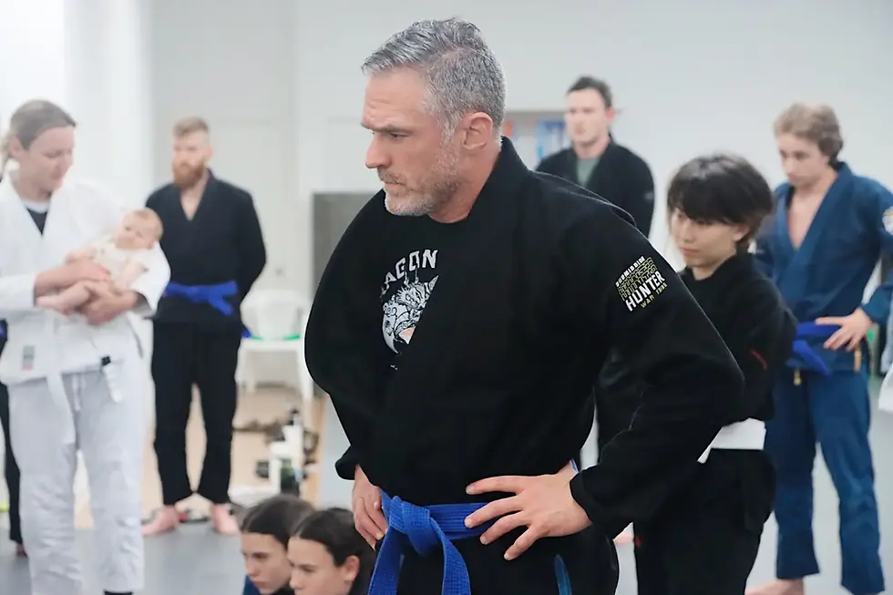 Adult professionals training Brazilian Jiu Jitsu at Liberdade BJJ in Nashville during an evening class