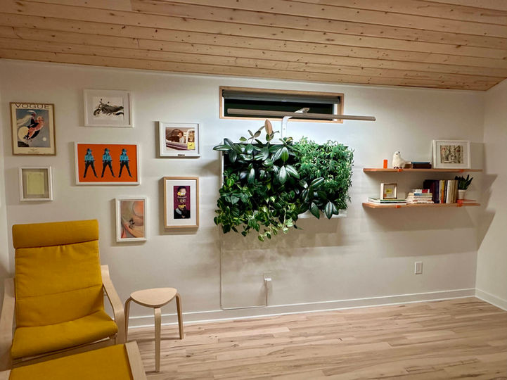 Modular living wall with integrated lighting by Vine Plants + Design in a Scandinavian home office.