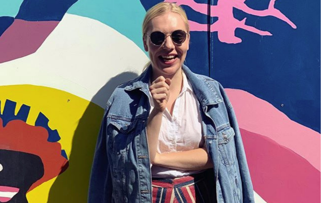 Thumbnail: happy blonde client wearing denim jacket, white shirt and multi coloured mini skirt