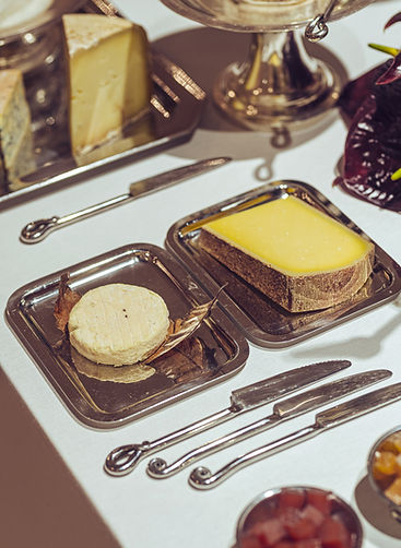 Cheese and bread selection on silver dishes – traditional French catering elements