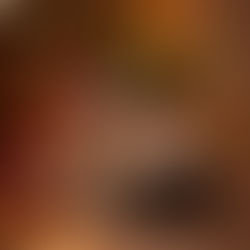 Two kids in Christmas hats smile while watching a tablet. A lit Christmas tree glows in the blurred background, creating a cozy atmosphere. Beginning to understand tech presents at Christmas and understanding the importance of digital parenting advice.