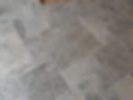 Close-up of natural stone floor tiles with grouted joints