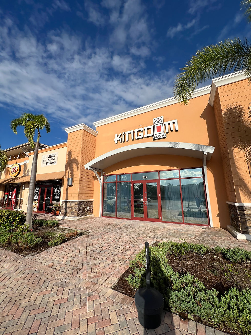Exterior view of Kingdom Sushi in Sympatico Plaza, Port St. Lucie, with new signage on the storefront under a bright blue sky.