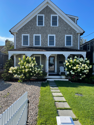 Cape Cod coastal cottage exterior with sun-worn shingles and summer light