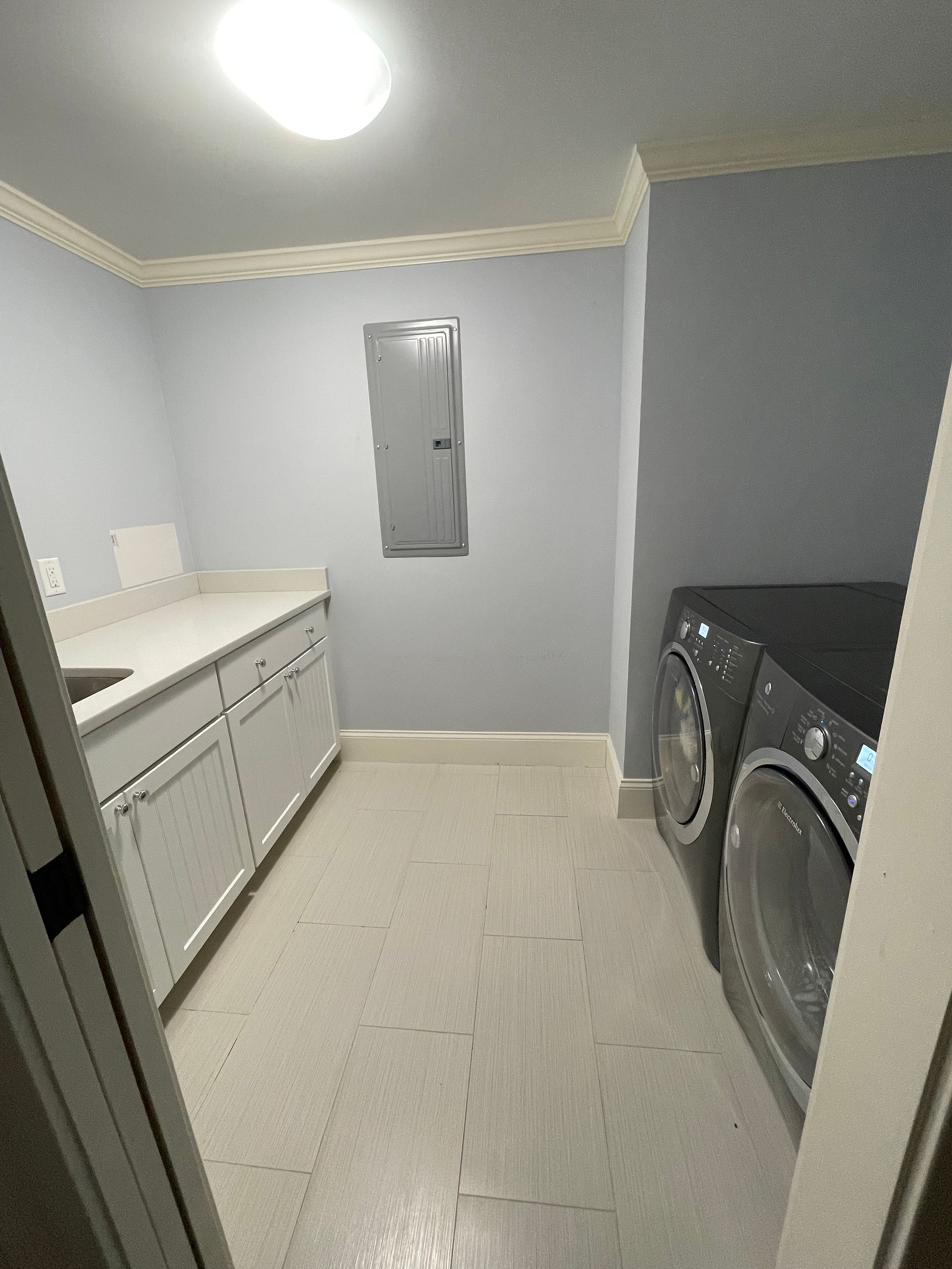 Laundry room before transformation with outdated finishes and no defined function