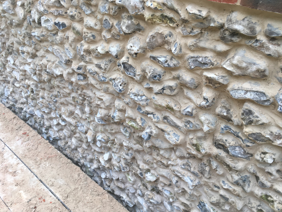 close up of flint wall detail with lime putty mix at hampshire barn build