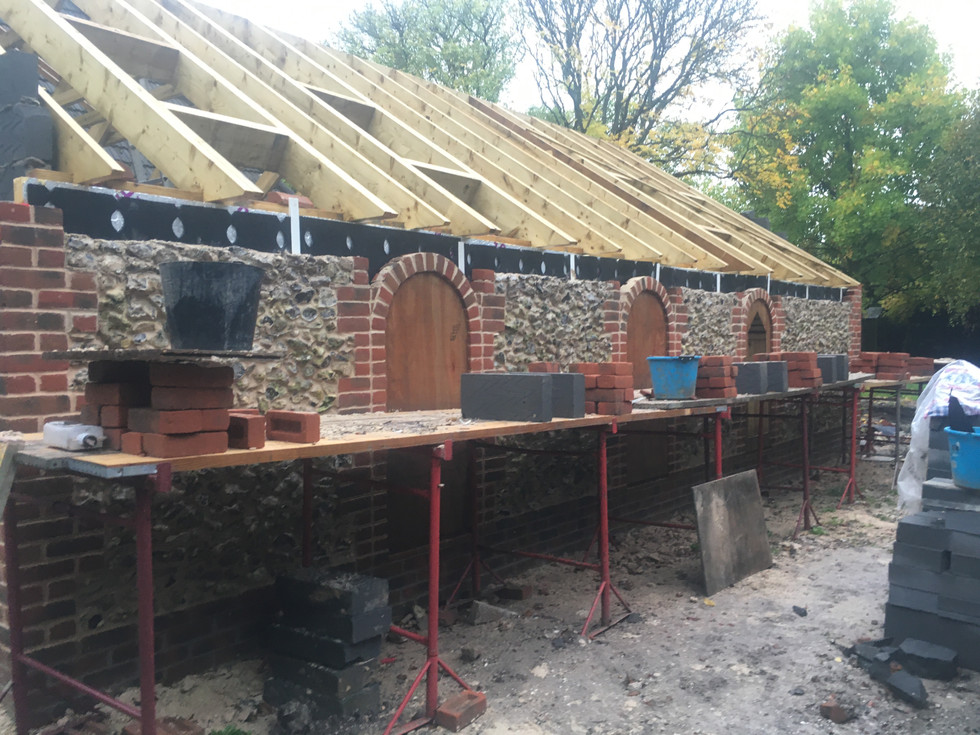 red brick detail on top of flint walls to cap ready for roof timbers