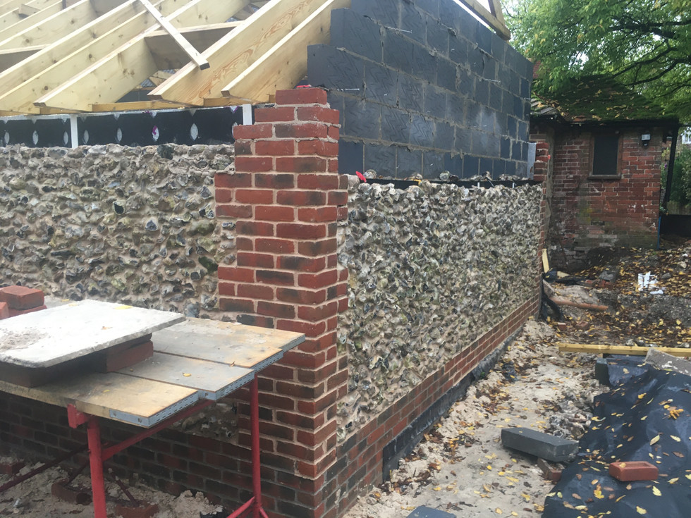 red brick coins for detail corners of flint build barn in wickham in hampshire