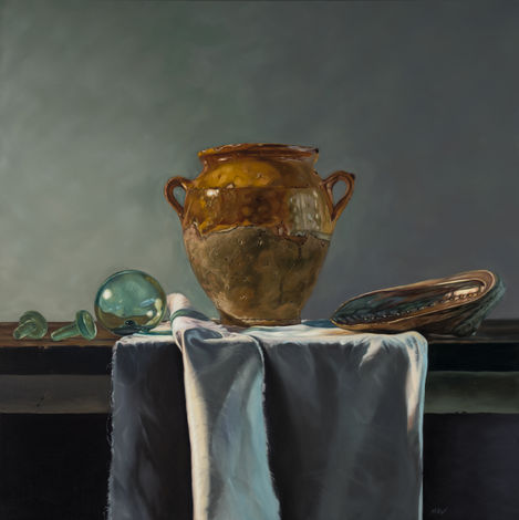 still life oil painting of an antique confit pot, glass float, glass bottle stoppers and an abalone shell on folded white drapery with dramatic lighting
