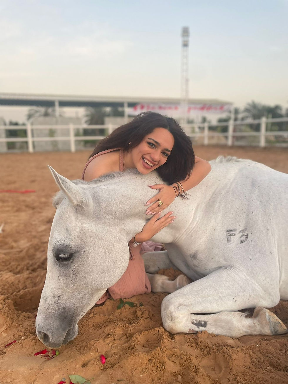Aaliyah hugging a horse