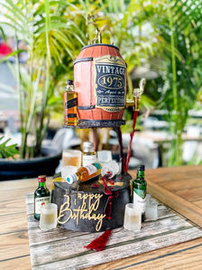 whiskey barrel elevated cake with a black cake with mini bottles of whiskey also with edible shot glasses for a males 50th birthday Sydney cakes Sutherland shire cakes gluten free cake