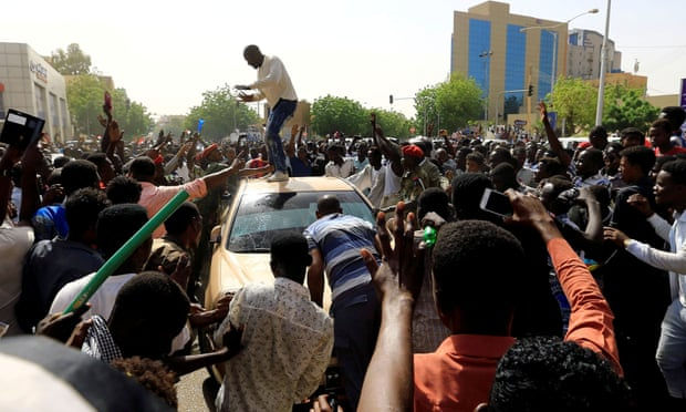 Sudanese demonstrators block the vehicle of an army officer in Khartoum as they protest against Bashir being replaced by a military-led transitional council. Photograph: Reuters