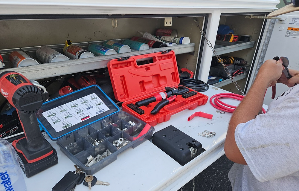 Marine technician using diagnostic tools to troubleshoot a boat system.