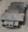 Black automotive electronic module on concrete, with connector and faded printed part numbers 33920 94L30 and BT56271.