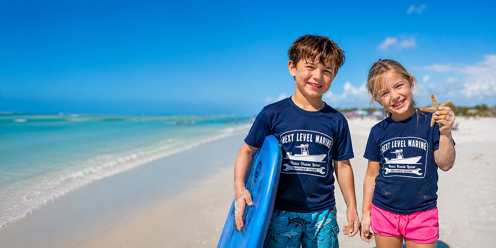 Two children on the beach wearing Next Level Marine t-shirts.