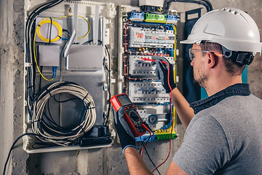man-an-electrical-technician-working-in-a-switchboard-with-fuses_Easy-Resize.com.jpg