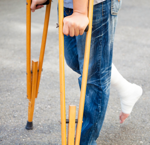 Individual on crutches symbolizing personal injury and workers’ compensation legal services.