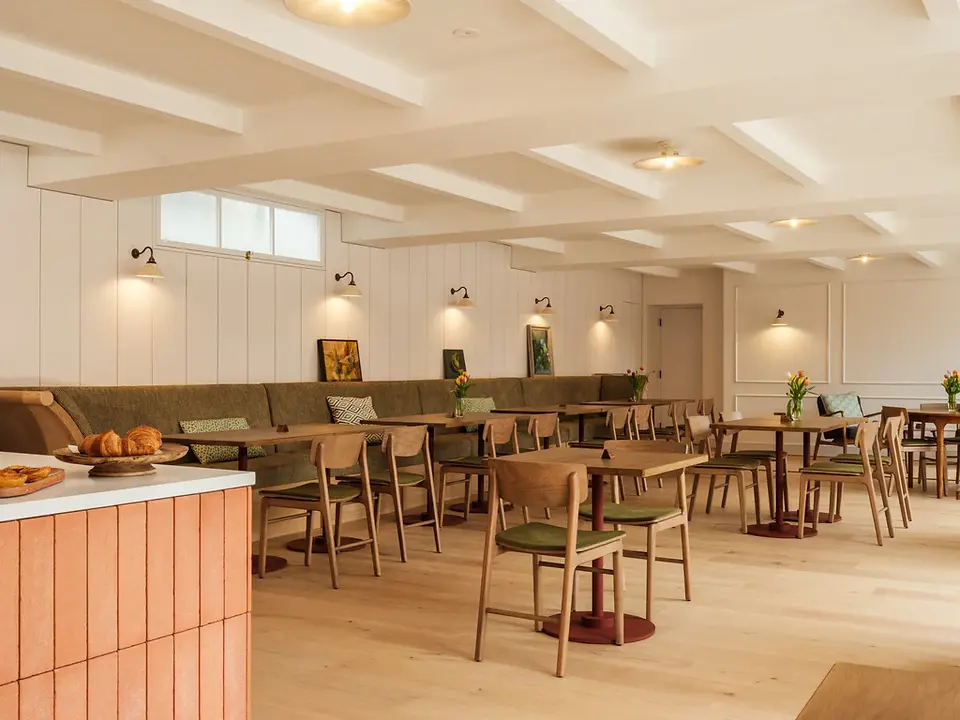 Restaurant dining area with wooden tables and warm lighting