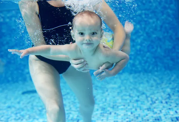 little-boy-learning-to-swim-in-a-swimming-pool-2021-08-26-22-40-03-utc.webp