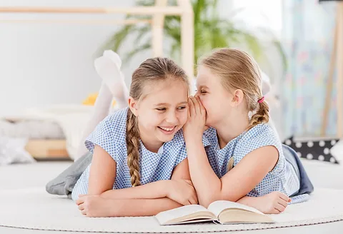 two-girls-talking-and-laughing-WAHFSU4_j.webp