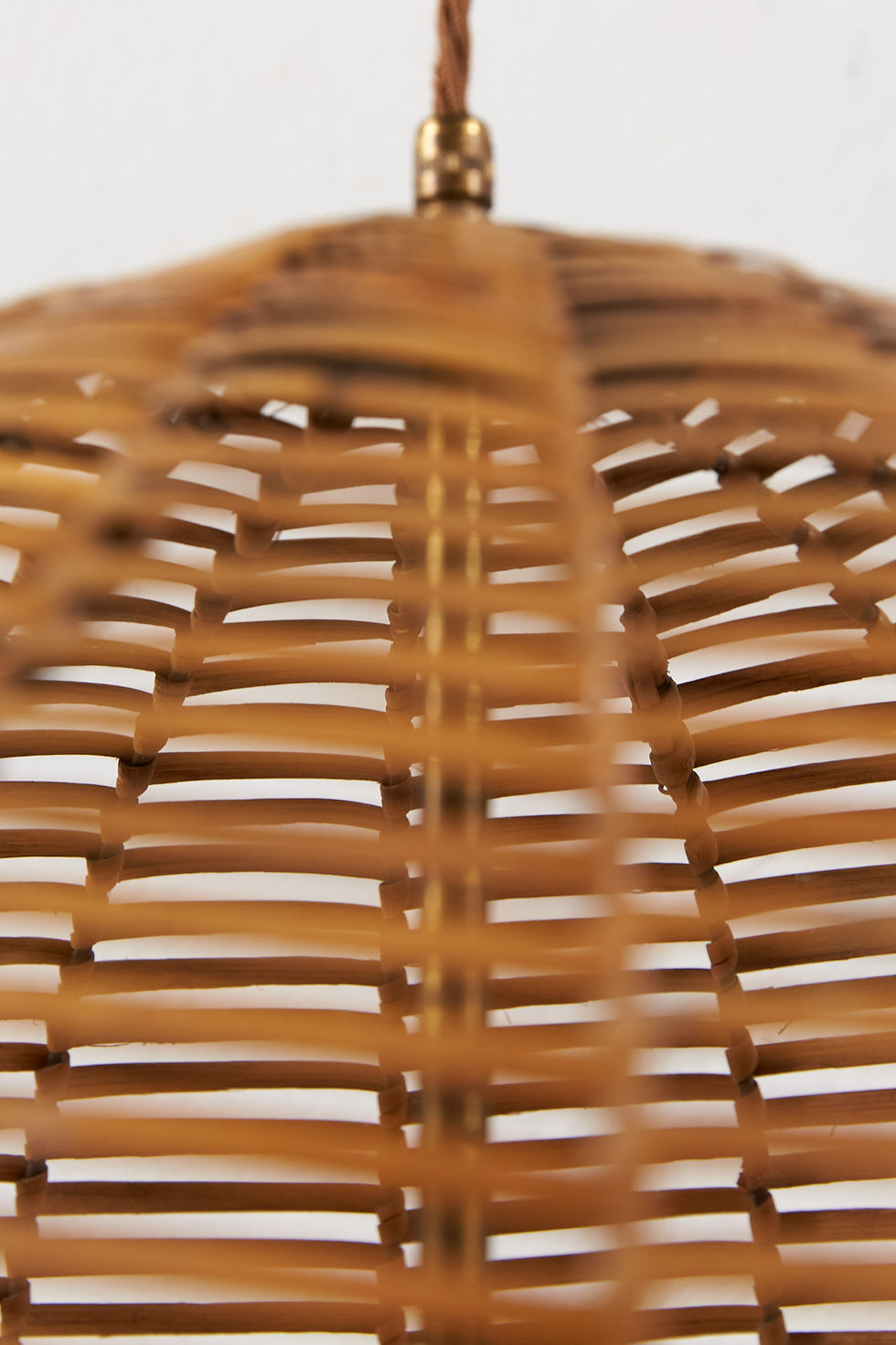 Thumbnail: A mid-century Italian pendant light with a finely woven cane shade and brass fittings.