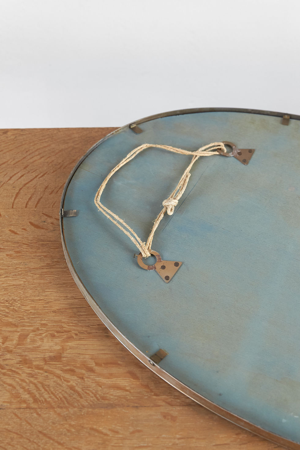 Thumbnail: A pair of Italian oval wall mirrors with original mirror plates set within nickel-plated brass frames. The slim frames are fi