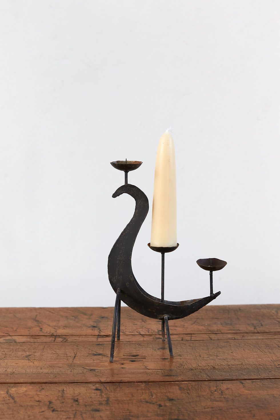 A hand-forged iron three-light pricket candelabrum in the form of a stylised long-necked bird.