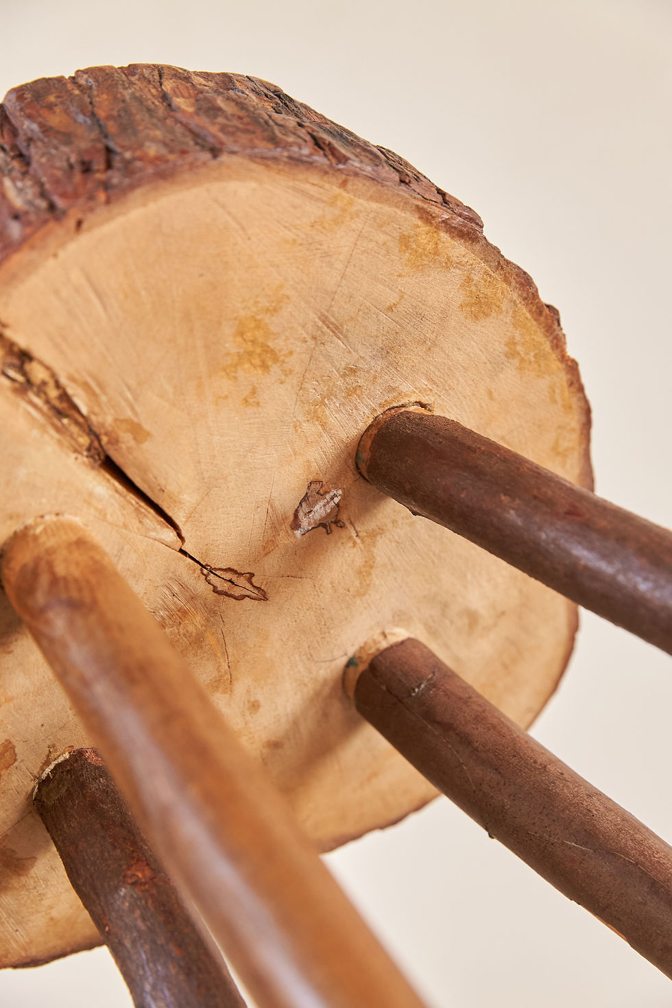 Thumbnail: A simple rustic stool dating from C1960–70, with a thick slab top retaining its original bark edge, set on four stick legs
