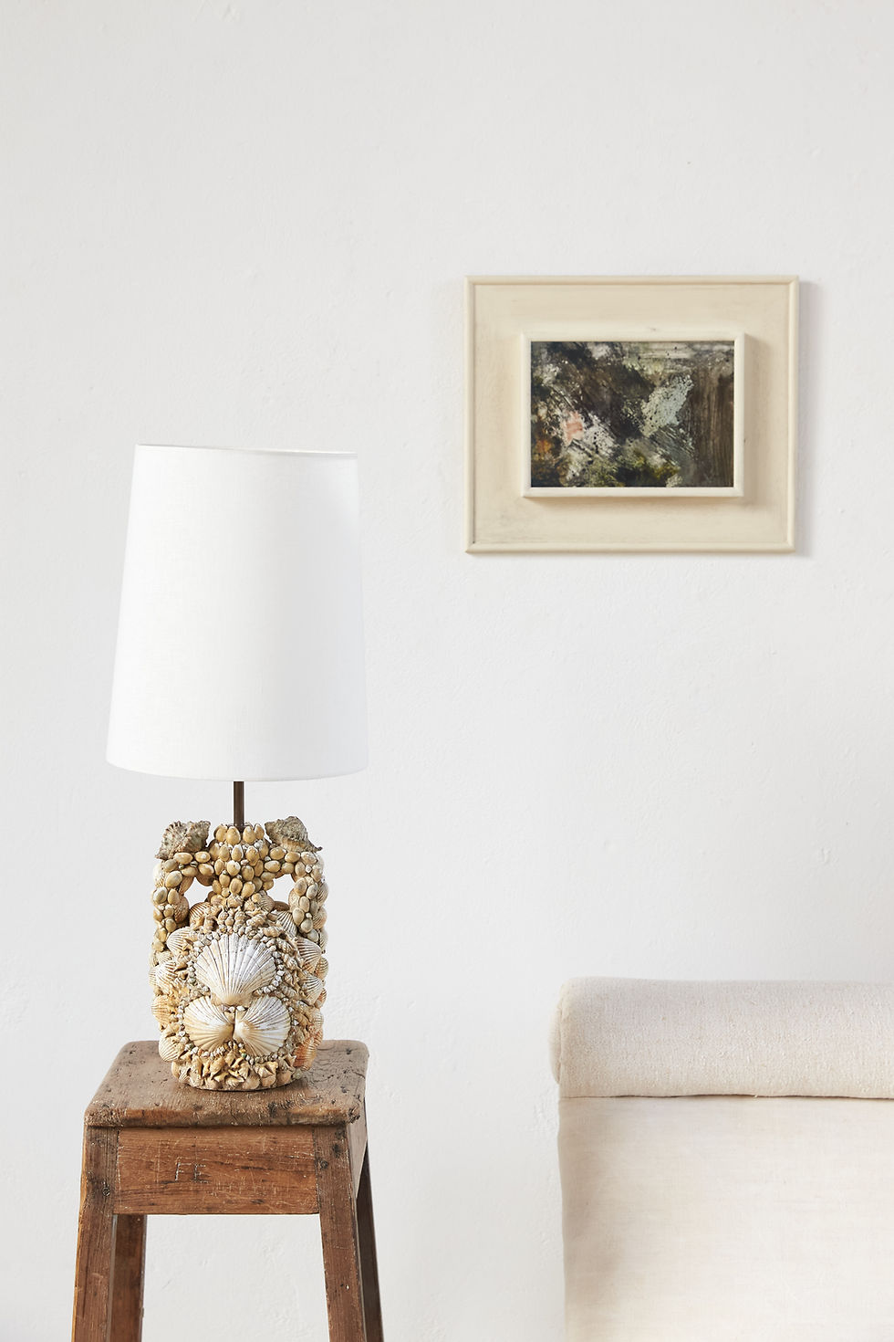 An early 20th-century shell-encrusted vessel, later converted to a table lamp