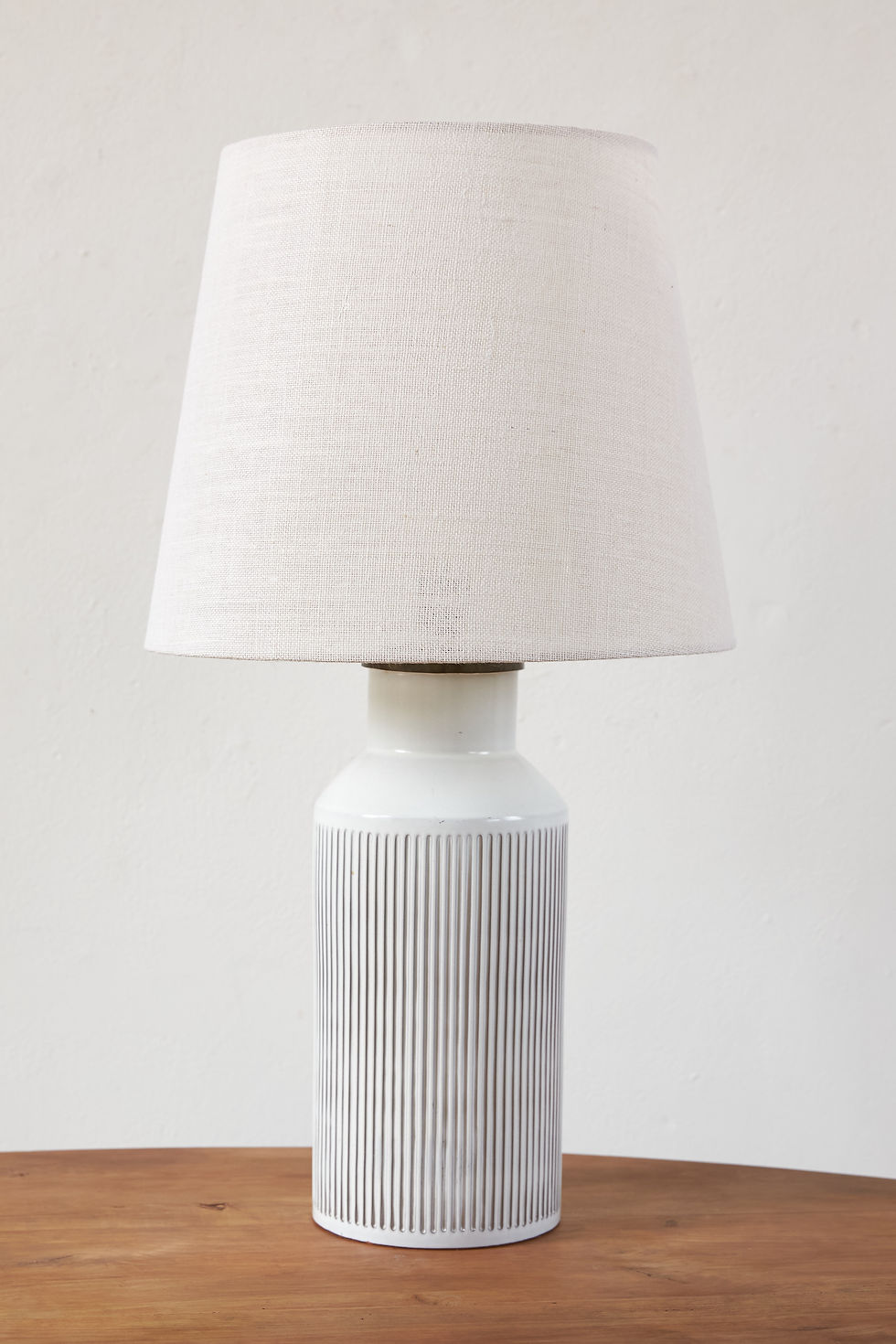 Thumbnail: pair of generously sized chalk-white Swiss ceramic table lamps from the 1960s with a ribbed white glazed base and brass fini