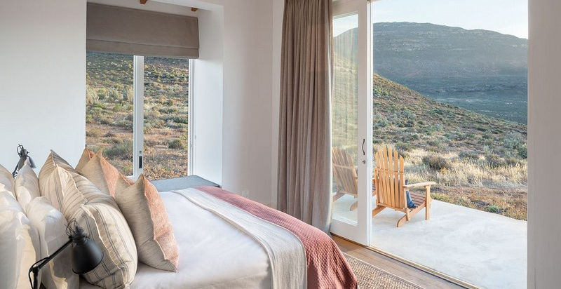 Guest suite with windows open looking over the view at Cedarberg Ridge Lodge in The Western Cape, South Africa with Safari Ambitions