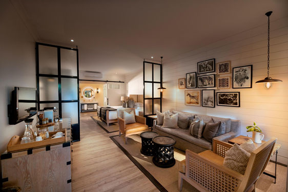 Guest Area with sofas and chairs and pictures on walls with glass area dividers